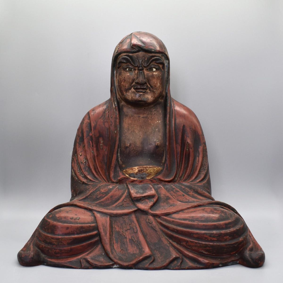 Red Lacquered Seated Daruma (Bodhidharma) with Glass Inlaid Eyes