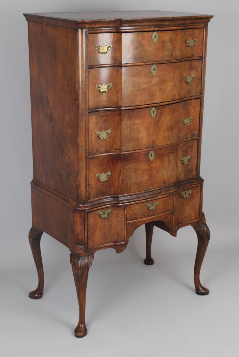 Queen Anne revival walnut chest on stand with a shaped front