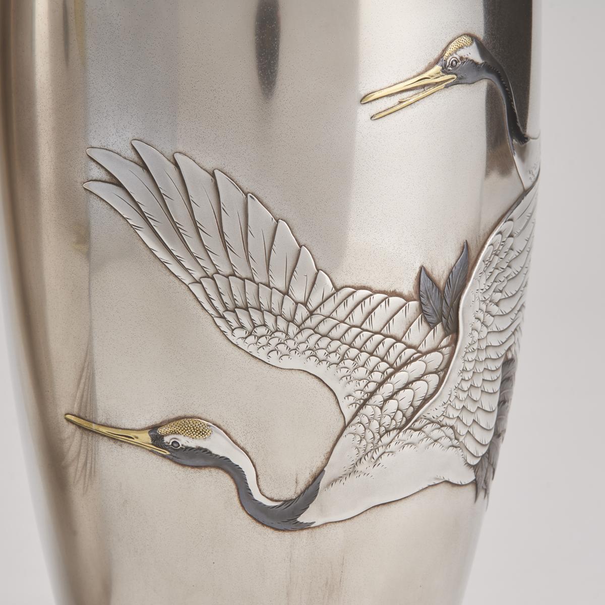 A stylish pair of Japanese silver vases depicting flying cranes (Circa 1915)