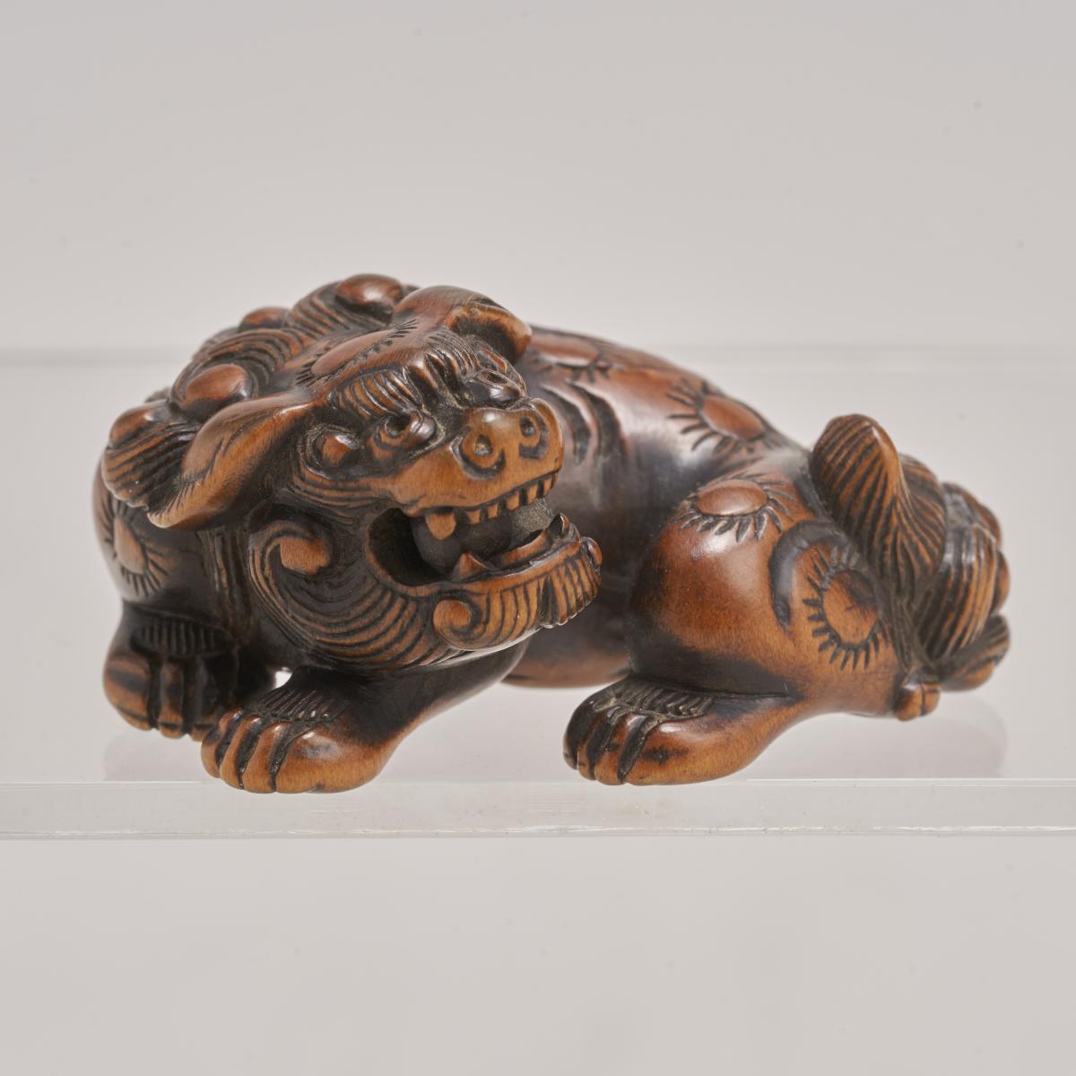 A charming 18th Century Japanese carved-wood Netsuke of a Shishi/Lion Dog