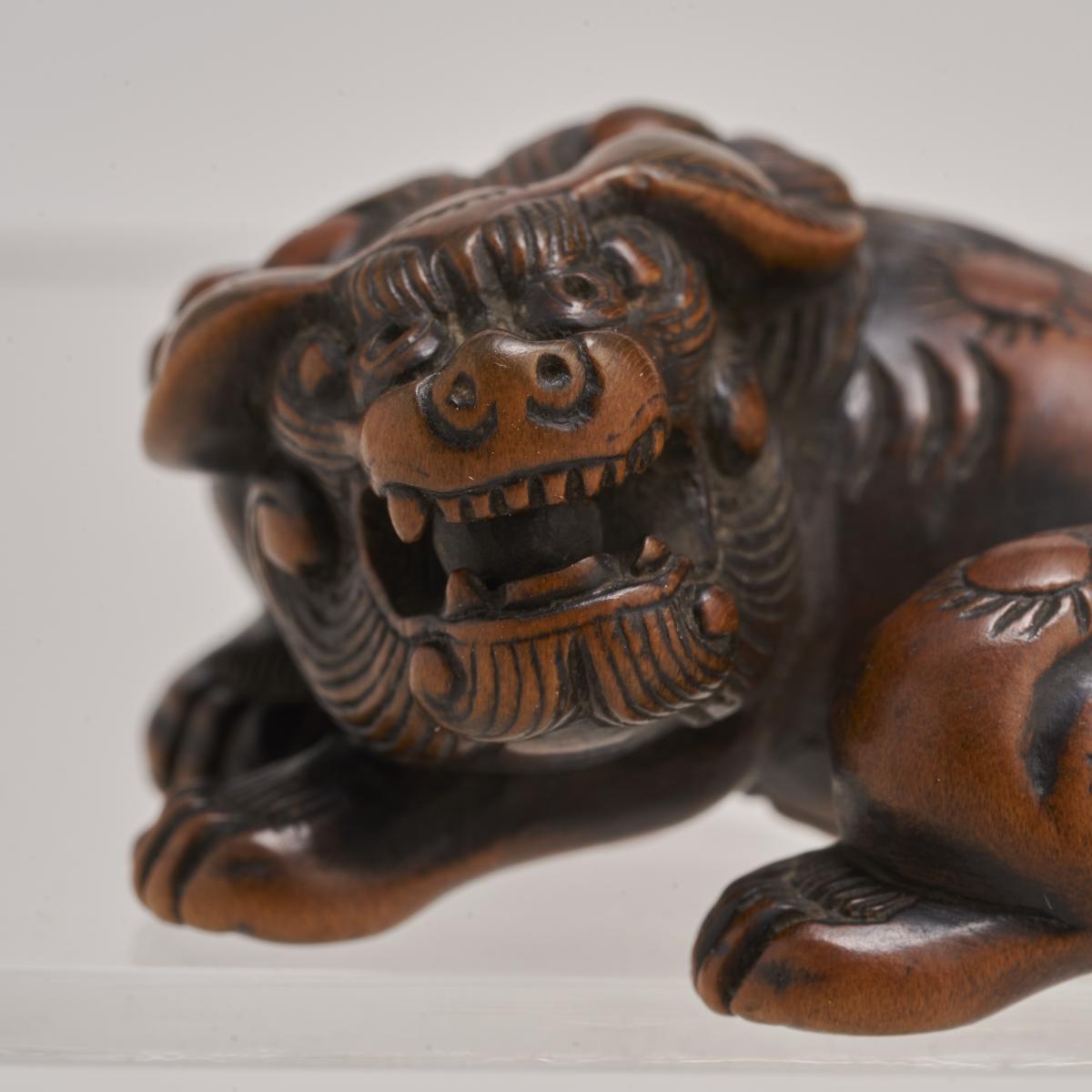 A charming 18th Century Japanese carved-wood Netsuke of a Shishi/Lion Dog