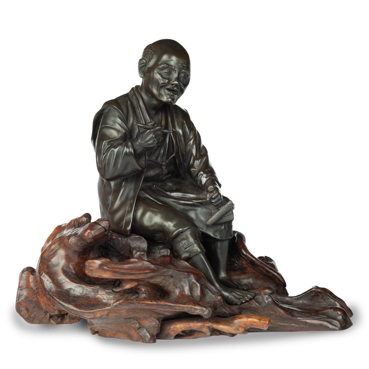 Meiji period bronze of a seated man smoking