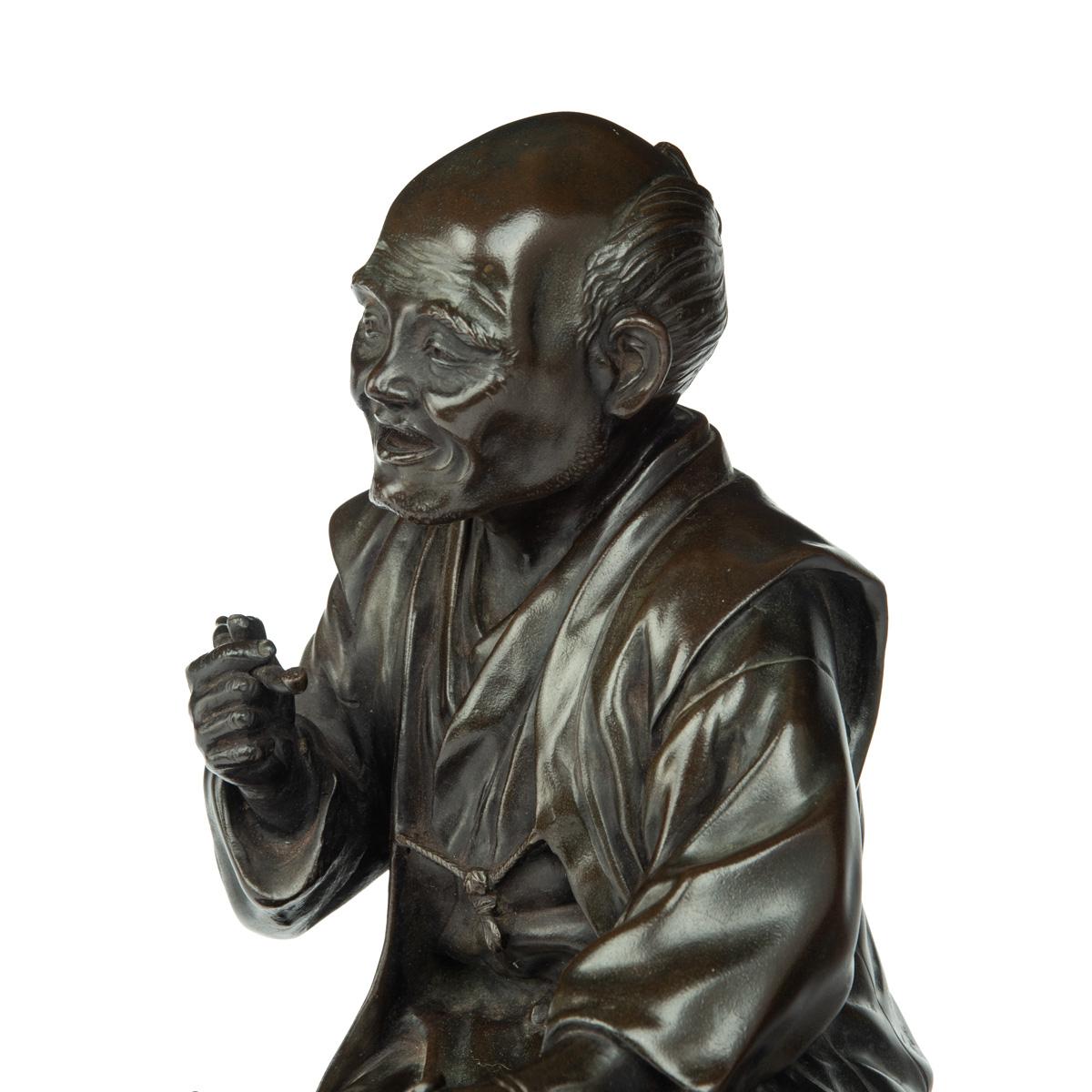 Meiji period bronze of a seated man smoking