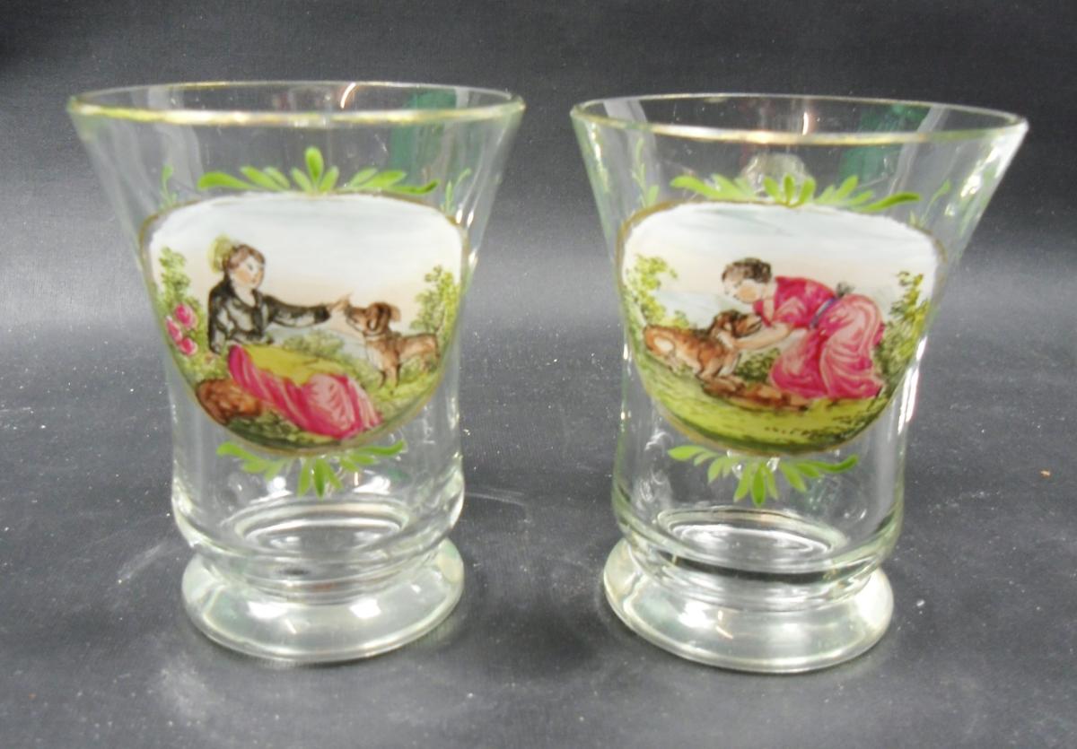 A pair of glass cups painted with a girl and a dog Bohemia circa 1820