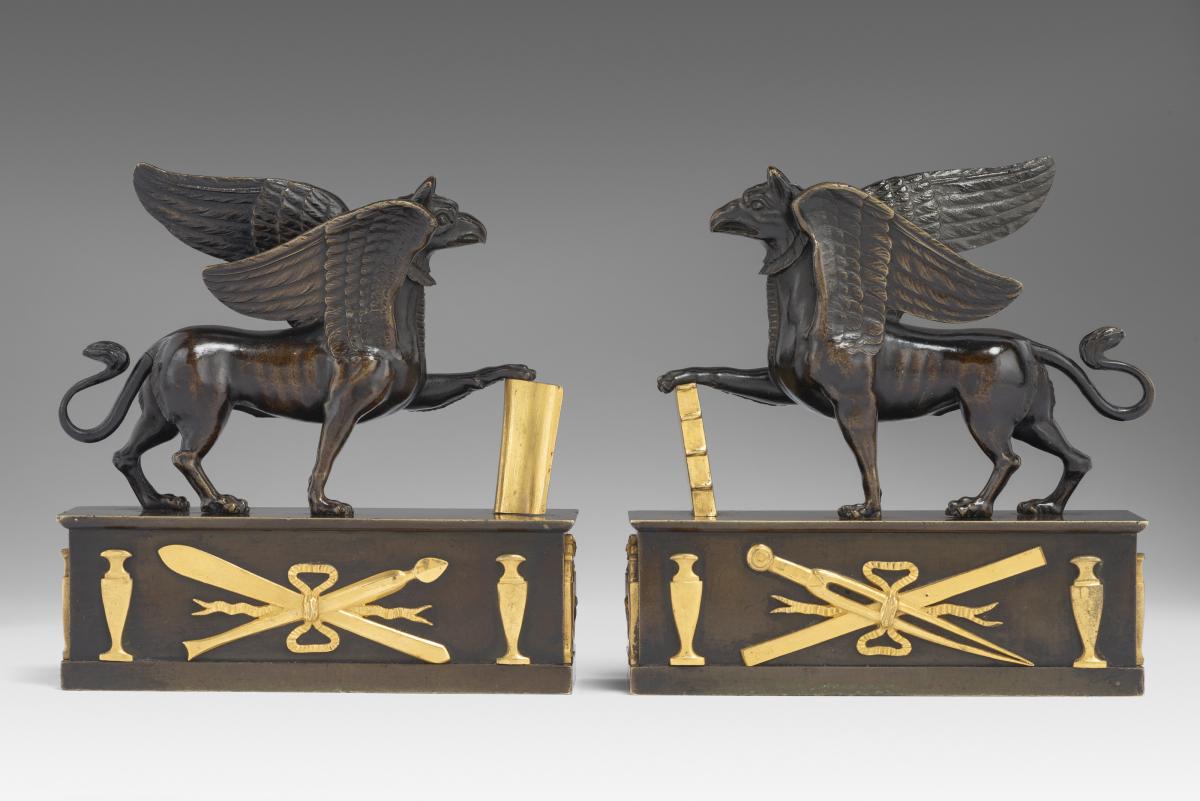 In the manner of Alexis Decaix (c. 1753-1811): A Pair of Regency Gilt-Bronze and Patinated-Bronze Griffin Paperweights