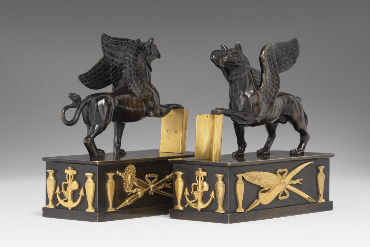 In the manner of Alexis Decaix (c. 1753-1811): A Pair of Regency Gilt-Bronze and Patinated-Bronze Griffin Paperweights