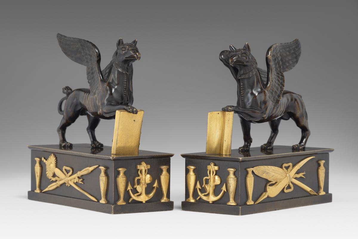 In the manner of Alexis Decaix (c. 1753-1811): A Pair of Regency Gilt-Bronze and Patinated-Bronze Griffin Paperweights