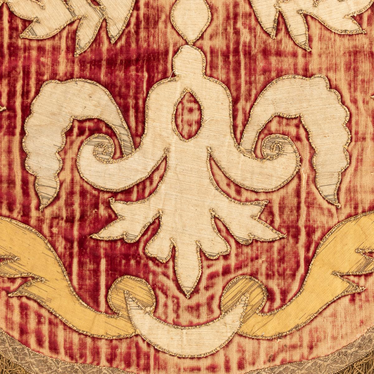 A 17th century red silk velvet, silk and metallic thread appliqué panel, Italian