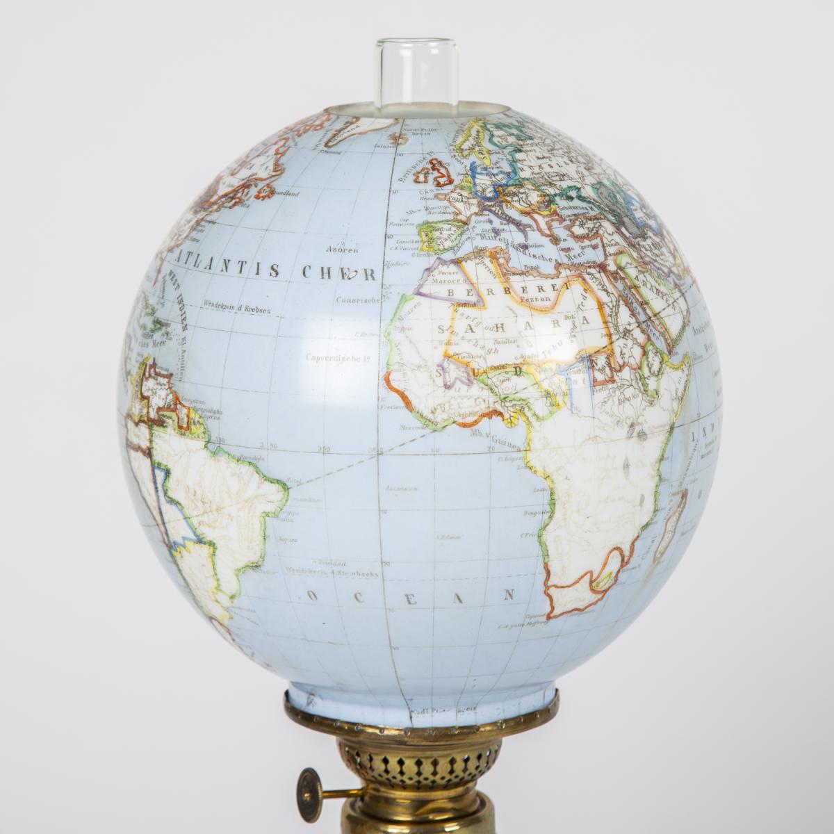 Oil lamp with an illuminating globe shade by Stelzig, Kittel & Co