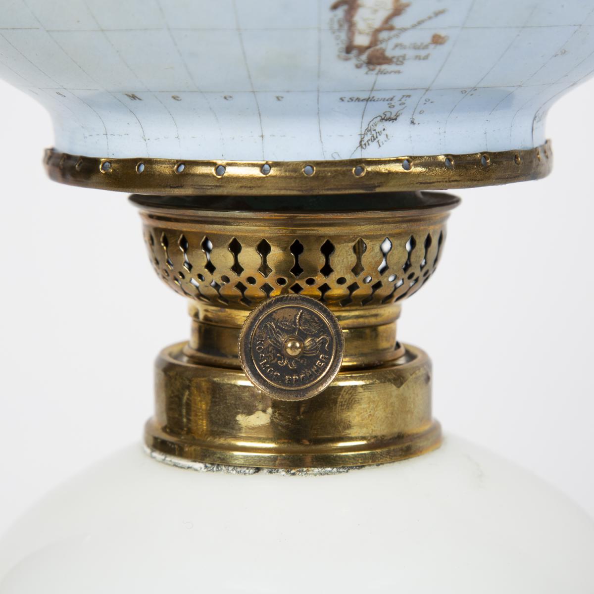 Oil lamp with an illuminating globe shade by Stelzig, Kittel & Co