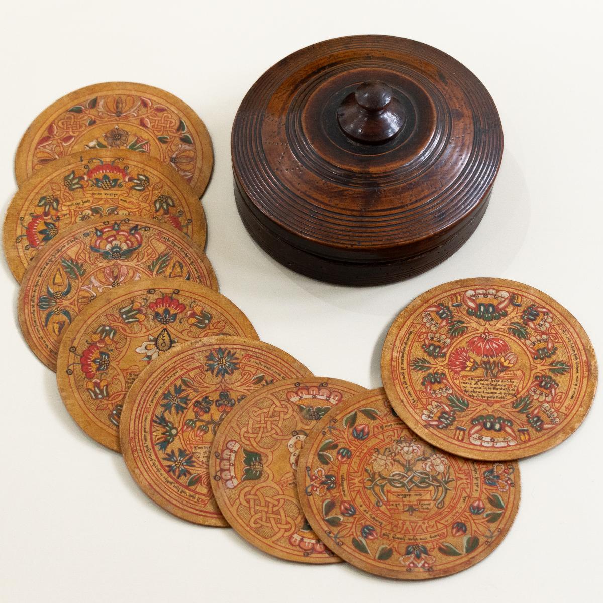 A rare and fine set of eight Elizabeth I beech/sycamore, polychrome-decorated and gilt roundels or trenchers, in original fruitwood box, circa 1580