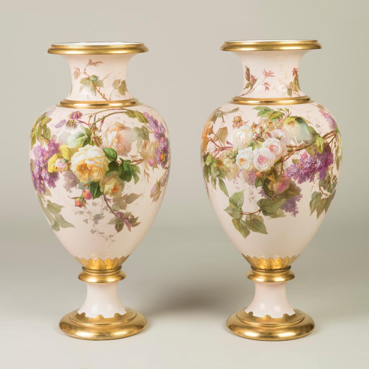 A Rare Pair of Pink Paris Porcelain Vases  The rare pink colour made popular in the 1870s and favoured by the Empress Eugenie, with delicate two-tone gilding, both vases of ovoid baluster shape, on a shaped foot, with floral motifs depicting roses, purple bellfowers and foliage with delicate realism. Both signed by the artist P. Hartwig, with one dated 1876, keeping their original character and condition. French, one dated 1876
