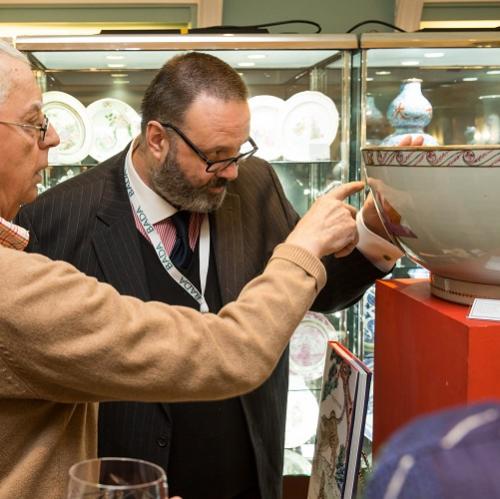 A client examining a chinese export porcelain bowl