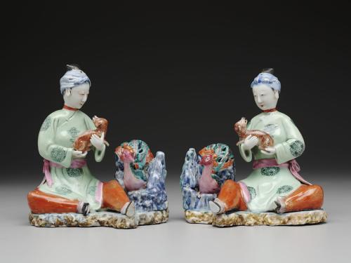 Pair of Chinese export porcelain figure groups of seated maidens with spaniels