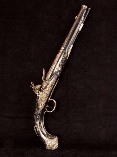 An ornate French export flintlock pistol with internal hammer_a