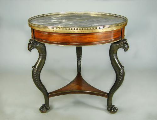 French Empire marble topped circular mahogany table with brass mounts and bronzed monopodia supports, c.1810