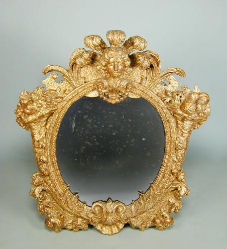 A George II period giltwood mirror of rare design, c.1730 