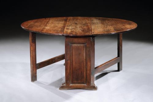 An exceptional, museum quality, mid-17th century cedarwood, panelled & trestle-end, gateleg table