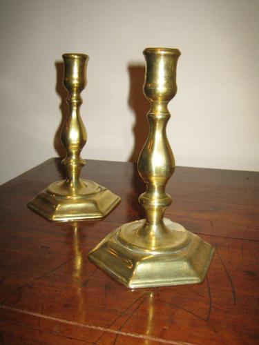 A good pair of early-18th century brass candlesticks with hexagonal bases