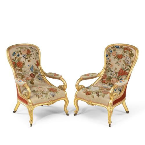 A pair of high Victorian gilt wood and needlework arm chairs by Gillows