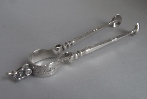 An extremely rare pair of Sugar Tongs modelled as a pair of Fire Irons.  Made in London in 1853 by Francis Higgins