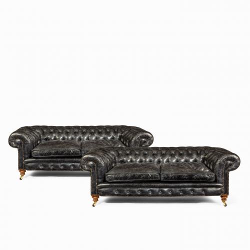 A pair of Victorian three seater walnut chesterfield sofas