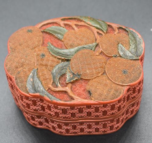 A Chinese three-colour cinnabar lacquer treasure box and cover