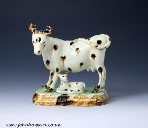 Yorkshire pottery figure of a cow with calf early 19th century England