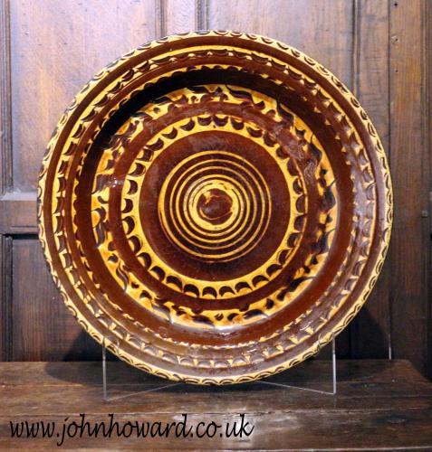 Antique English earthenware slipware circular dish with masterful decoration