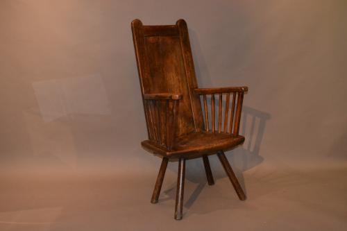 A stunning 18th century primitive armchair