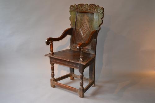 A mid 17th century oak wainscot armchair