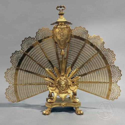 A Large Louis XVI Style Gilt-Bronze Fan Shaped Fire Screen With A Finely Cast Mask of Apollo.  French, Circa 1880. 