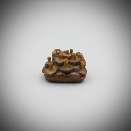 Pale Boxwood Netsuke of 19 Mushrooms in a Basket attributed to Tadashige