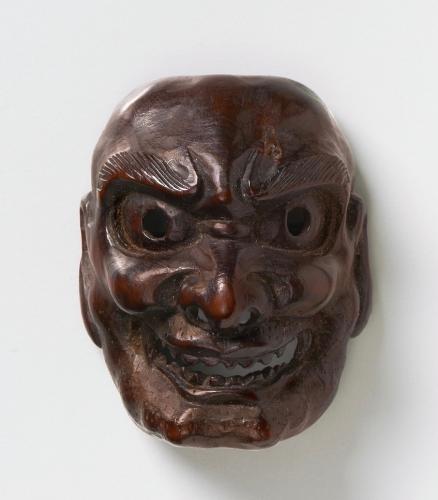 Dark wood mask netsuke of Shishiguchi