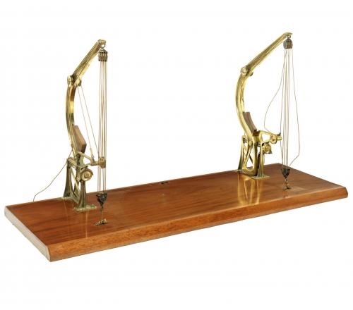 A late 19th century model of a pair of brass Davit type cranes