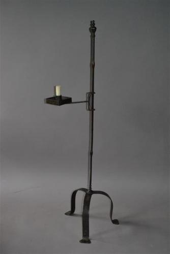 A wrought iron floor standing candle holder