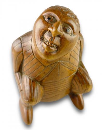 An amusing snuff box of a squatting man. French, early 19th century