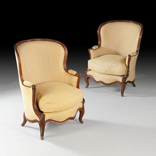 An overscale pair of 19th century walnut bergeres
