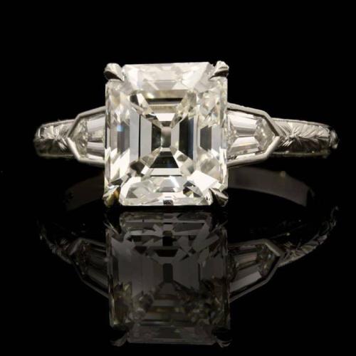A stunning 2.81ct emerald-cut diamond ring with diamond shoulders