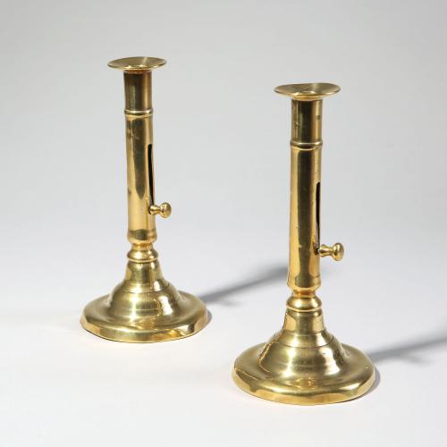 A pair of mid 18th century brass candlesticks