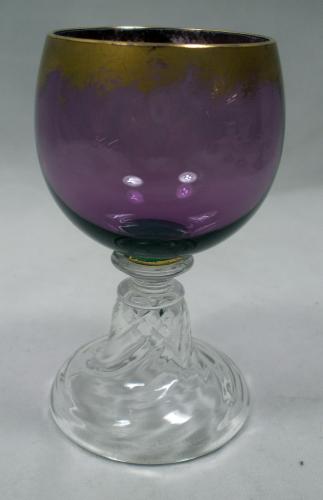 An amethyst and crystal wine glass with powdered gilt decoration