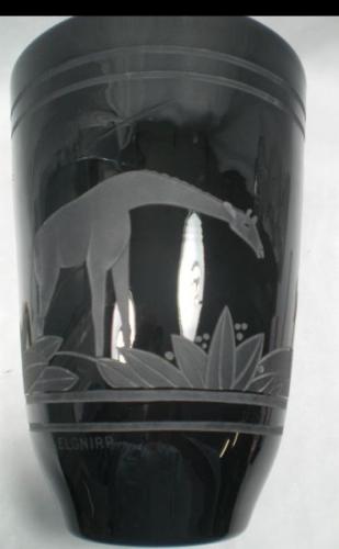 A black glass vase engraved with giraffes and marked 'Elgnirp' English/Continental c.1930