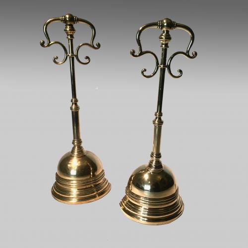 Two Regency brass door porters