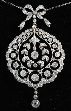 Edwardian Platinum set diamond movable pendant with bow top, circa 1910