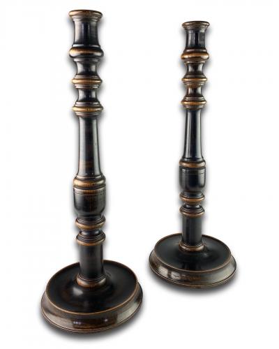 A large pair of ebonised walnut candlesticks. English, late 19th century