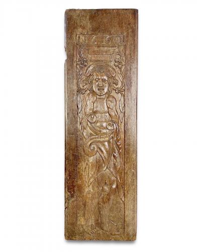 A large oak relief of a grotesque figure. French, dated 1660
