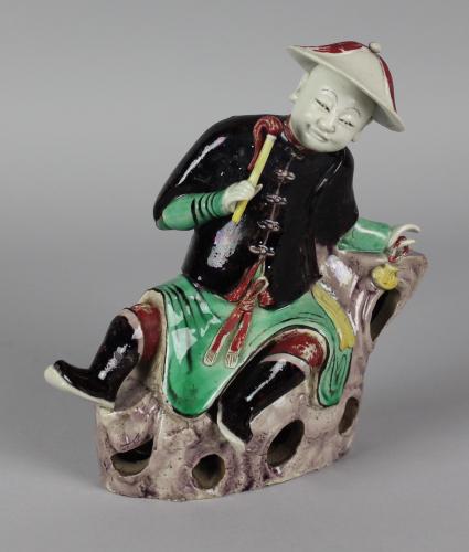A Rare Chinese ‘Famille-Verte’ Biscuit Figure of a Reclining Gentleman, Qing Dynasty, Kangxi Period