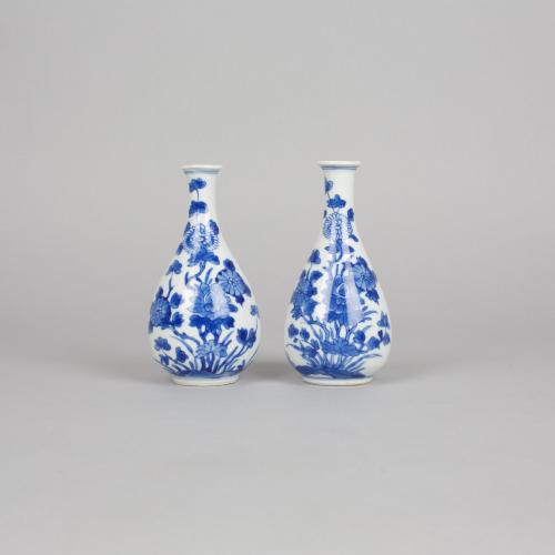 A pair of Chinese porcelain underglaze blue and white miniature bottle vases, Kangxi, 1662-1722