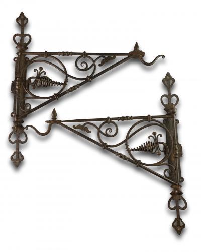 Pair of hinged wrought iron wall brackets. German, early 19th century