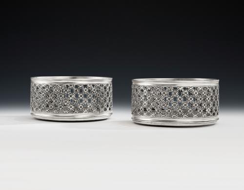 An exceptionally rare and unusual pair of Floral Trellis Work Silver Based Wine Coasters made in London in 1852 by Daniel & Charles Houle